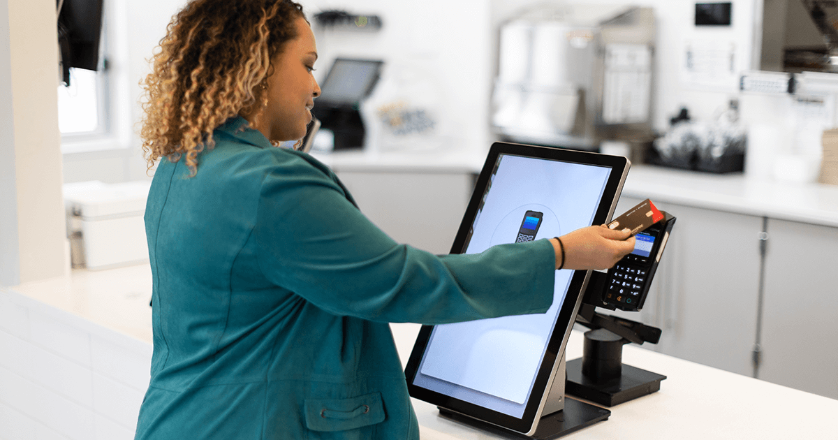 woman using kiosk point of sale system in a restaurant